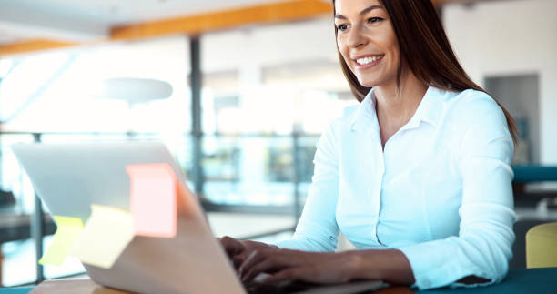 istock Attractive young female architect working on laptop 876679554