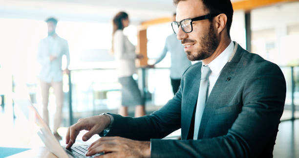 istock Professional handsome businessman using laptop at workplace 876681858