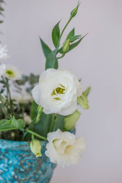 istock Whilte lisianthus in turquoise vase 876682300