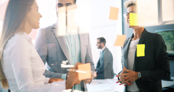 istock Picture of designers sticking notes in office 876685686