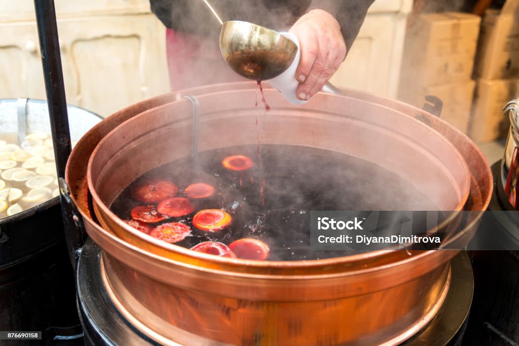 Pot of mulled wine with fruit and spices Christmas market and a pot of mulled wine with fruit and spices Mulled Wine Stock Photo