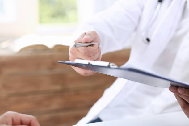 istock Male doctor hand hold silver pen and 876693274