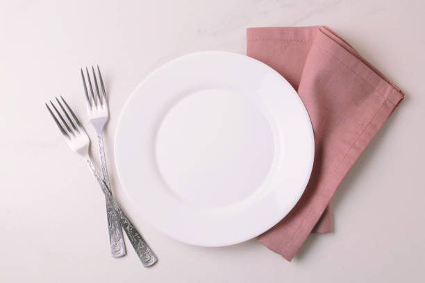 istock Food background. White empty plate, cutlery, napkin. Top view, copyspace. 876693754