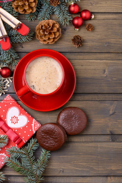 istock Red cup coffee with gift box and fir and cones tree 876693844