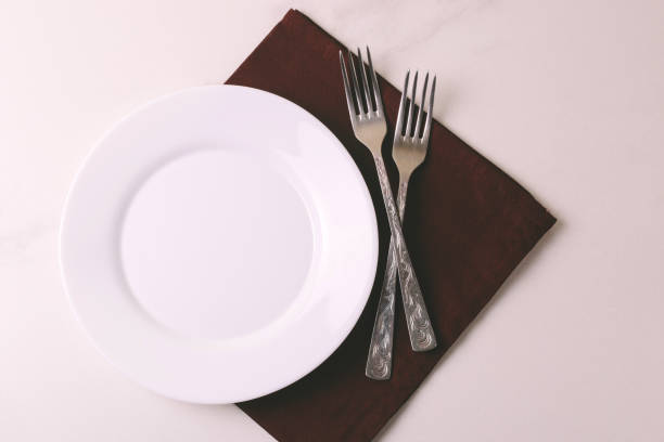 istock Food background. White empty plate, cutlery, napkin. Top view, copyspace. 876694384