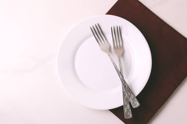 istock Food background. White empty plate, cutlery, napkin. Top view, copyspace. 876696988