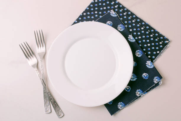 istock Food background. White empty plate, cutlery, napkin. Top view, copyspace. 876697192