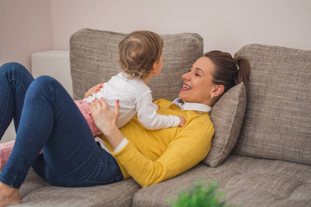 istock Young single mother playing with daughter 876697196