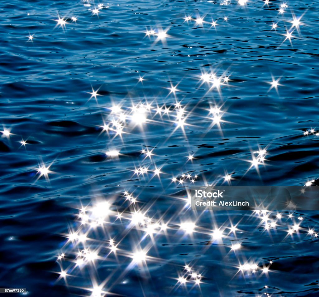 Glittering sea on moonlight Detail of a  moonlight reflecting in glittering sea Water Stock Photo