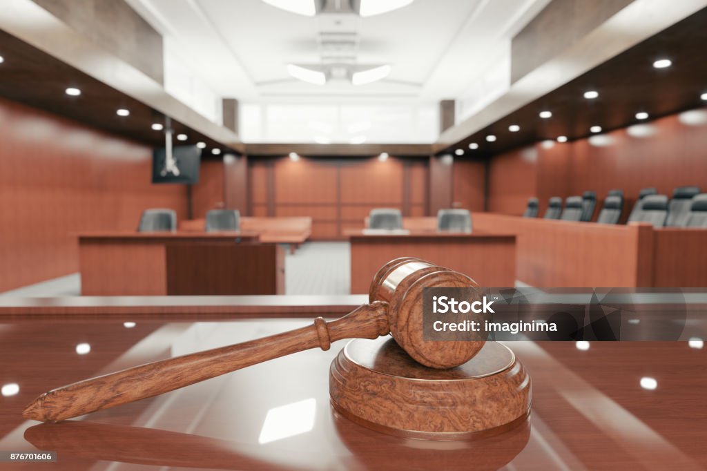 Courtroom And Gavel Interior of an empty courtroom with gavel and sounding block on the desk. Courtroom Stock Photo