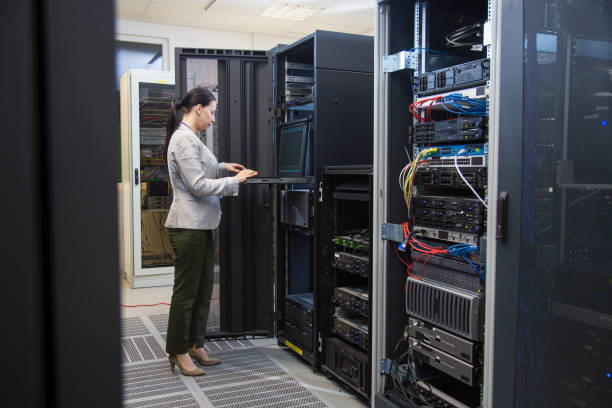 istock Female IT professional in server room 876704460