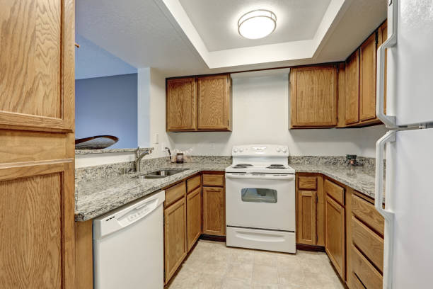 istock Small u shaped kitchen filled with wood cabinets 876704968