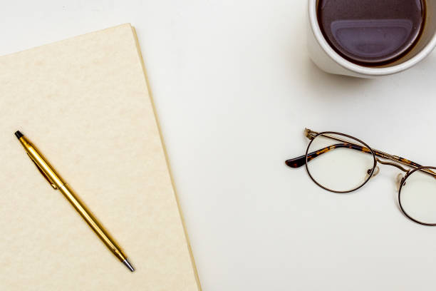 istock Notebook Glasses Coffee Mug Journal Diary on With Desk Minimal Close Up 876712074