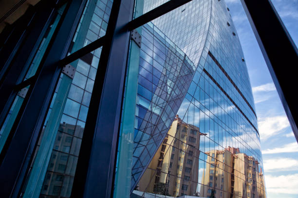 istock Building glass . Panoramic and perspective wide angle view to steel light blue background of glass high rise building skyscraper commercial modern city of future. Business concept of successful industrial architecture 876712788