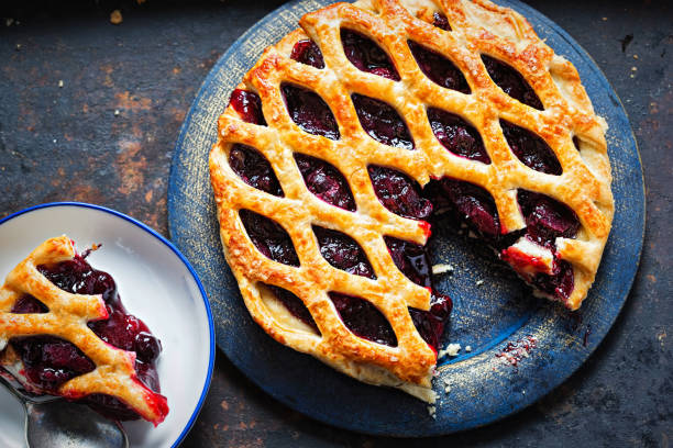 Lattice autumn fruit pie, with blackcurrant, blackberry, cherry compote in puff pastry pie stock photo