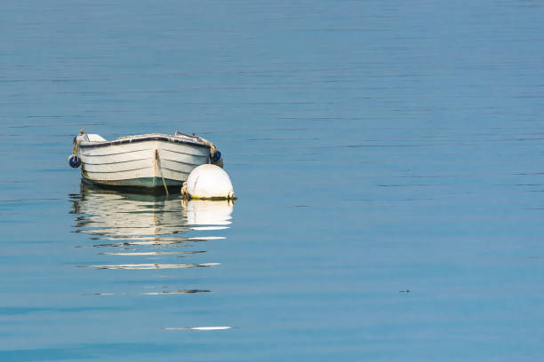 istock Rowboat, white boat and buoy 876737718