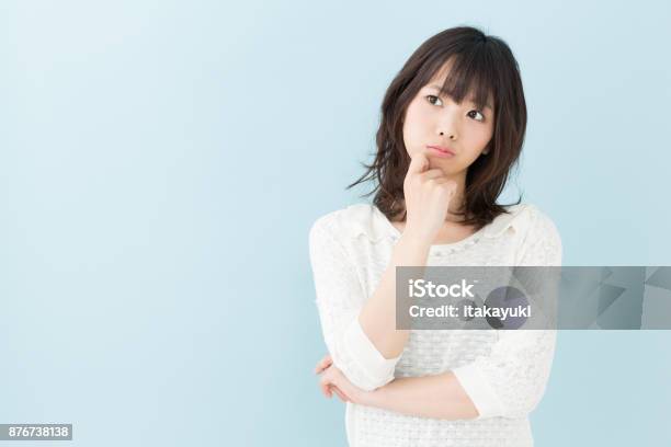 Portrait Of Attractive Asian Woman Isolated On Blue Background Stock Photo - Download Image Now