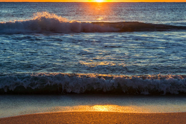 istock orange and blue sunshine splash on the sea shore 876738424