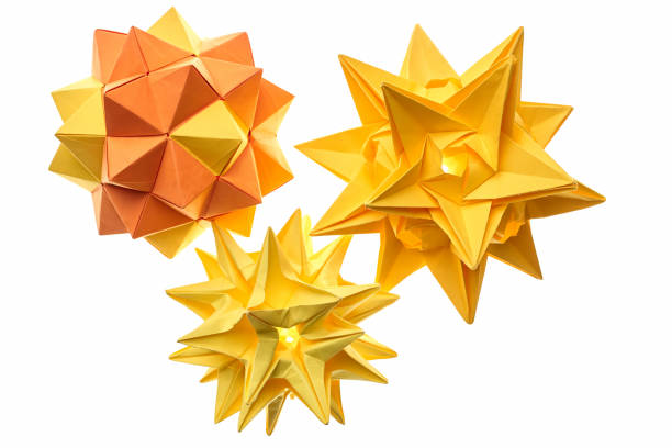 Origami stars for Christmas. Origami figures are made of colored paper. DIY toys for the Christmas tree. Copy space