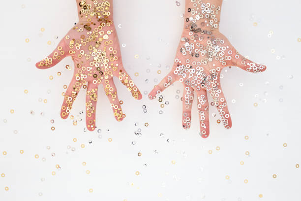 istock Female palms in gold and silver confetti 876756086