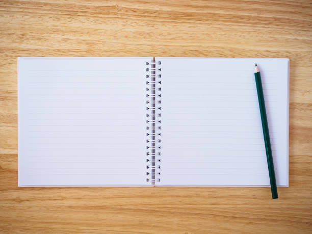 istock notebook top view with pencil on brown wood desk 876773826