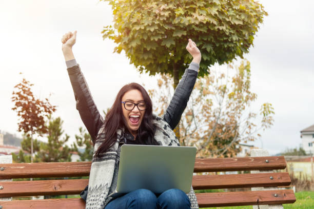 istock Happy woman with laptop 876774198