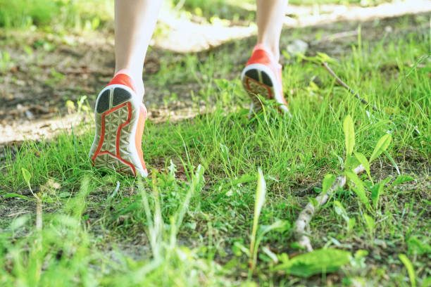 istock Girl runs along a country road. 876774368