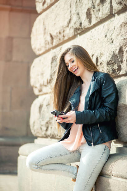 istock Excited student reading news on a smart phone 876774396