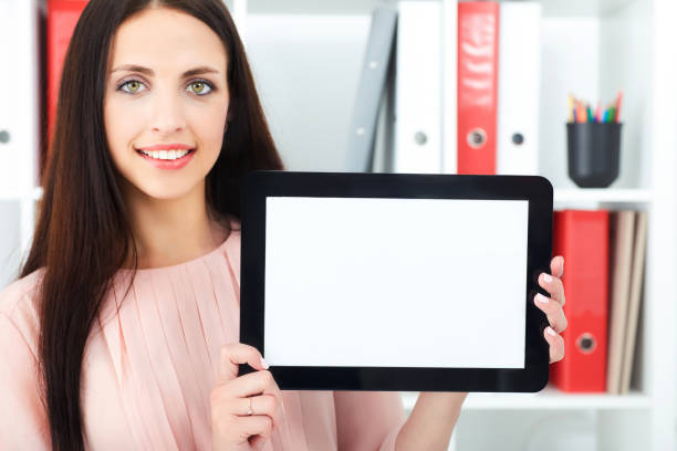 istock Young secretary holding a tablet with empty screen for text or picture. 876774496
