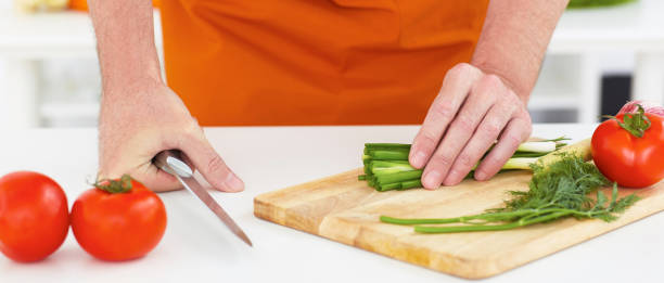 istock Man going to cut the onion couch with a knife. 876774614
