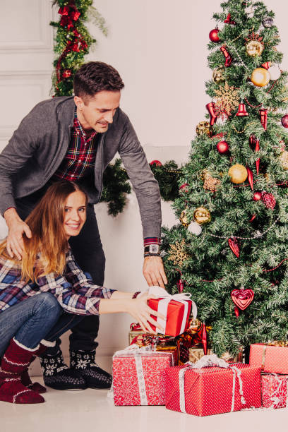 istock Happy parents put christmas gifts 876774656
