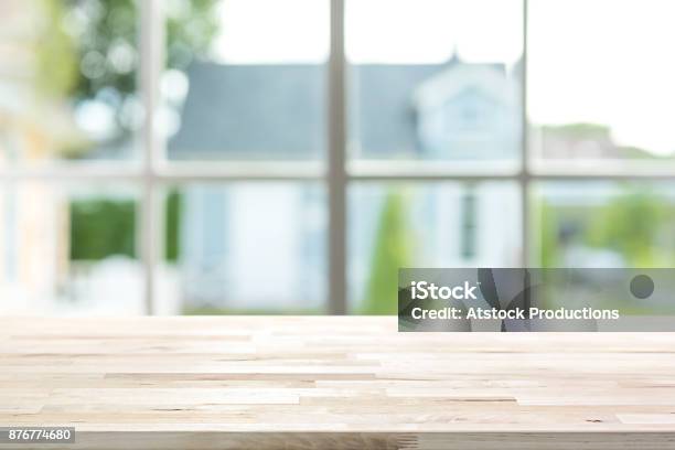 Wood Table Top Inside The House With Blur Green Garden Outside Window In Background Stock Photo - Download Image Now