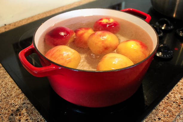 istock Peaches being boiled in a pot so the skins can be removed 876786900