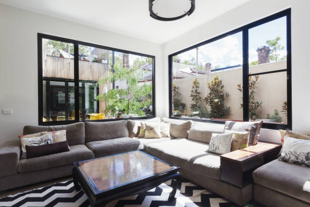 istock Living room sofa with large windows looking onto a courtyard 876787064