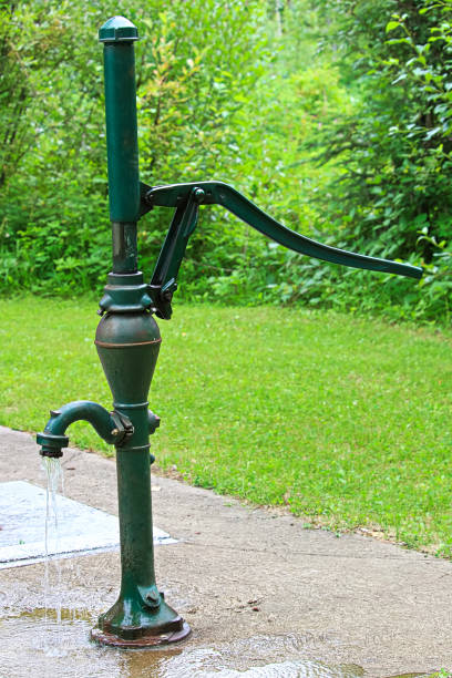 istock An old fashion hand pump pouring water 876787466