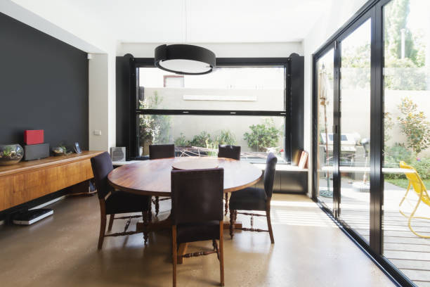 family dining room extention with large glass windows and doors in australian contemporary home - showcase interior inside of domestic room indoors imagens e fotografias de stock