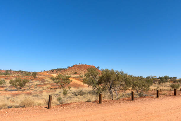 istock Arid landscape and wooden bollards at Lark Quarry 876803228