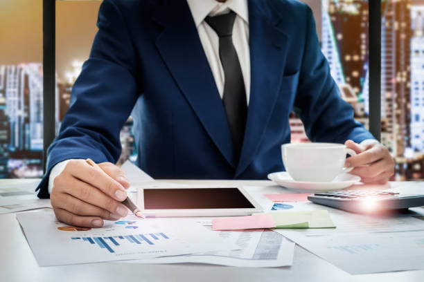 istock Young business man working at office with tablet,calculator,post 876810278