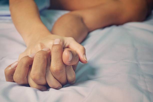 man and woman hands having sex on a bed. - romance sensuality couple bed imagens e fotografias de stock