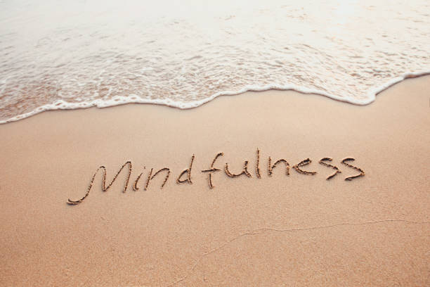 mindfulness concept, mindful living mindfulness concept, mindful living, text written on the sand of beach mindfulness stock pictures, royalty-free photos & images