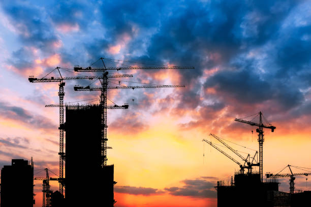 istock Beautiful urban construction site silhouettes at sunset 876818934
