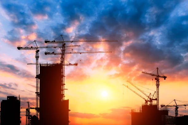 istock Beautiful urban construction site silhouettes at sunset 876819226