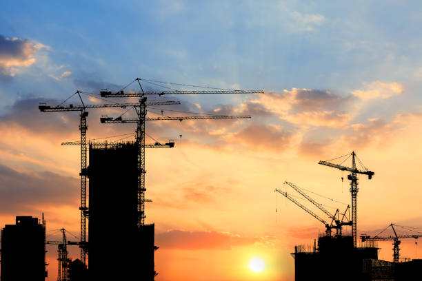 istock Beautiful urban construction site silhouettes at sunset 876819272