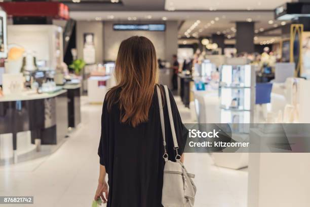 Young Asian Woman Walking In Cosmetics Department At The Mall Stock Photo - Download Image Now
