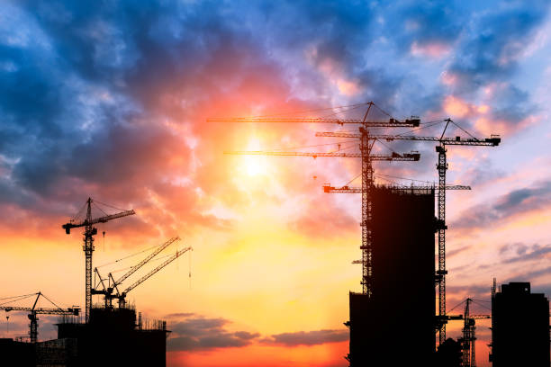 istock Beautiful urban construction site silhouettes at sunset 876821806
