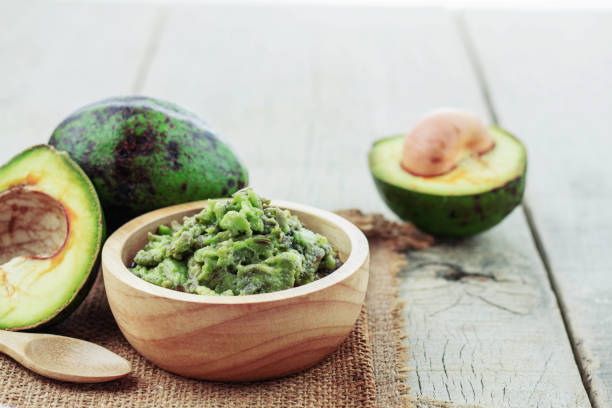 istock Avocado on wooden floor. 876824972