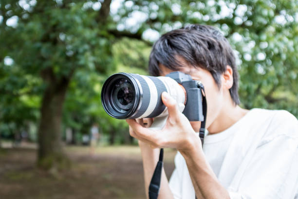 Man taking pictures Man taking pictures. telephoto lens stock pictures, royalty-free photos & images