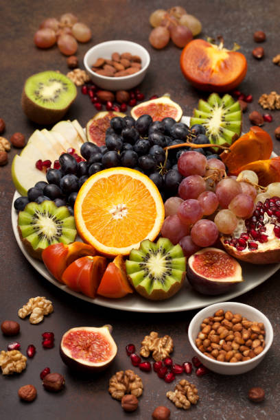 istock platter with fresh fruits and nuts 876825480