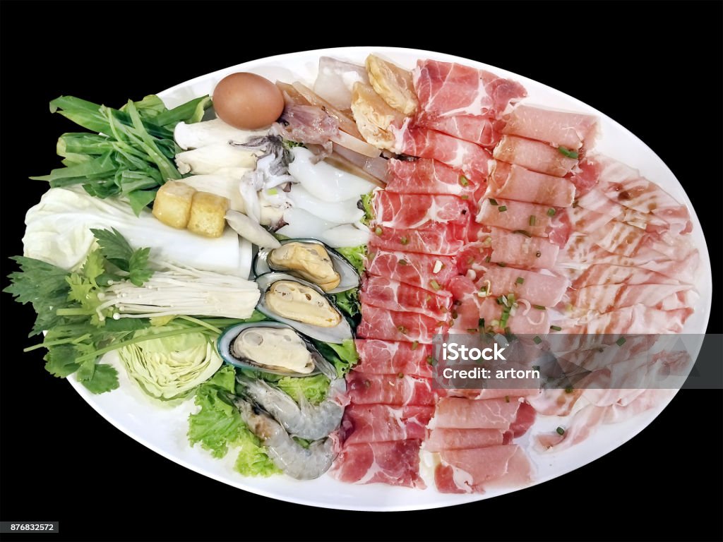isolated photography on black background with clipping path of mix Pork slice and seafood platter set served on big white plate dish top with rich soya sauce for Shabu or Sukiyaki Japanese hot pot style Asia Stock Photo