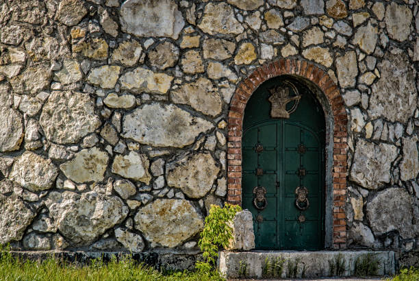 Wooden door to the tower of a stone fortress.